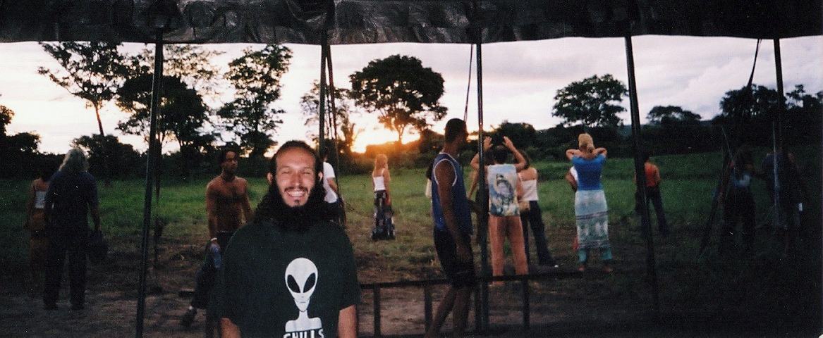 a Brazil trance party, dancers on the grass at sunset