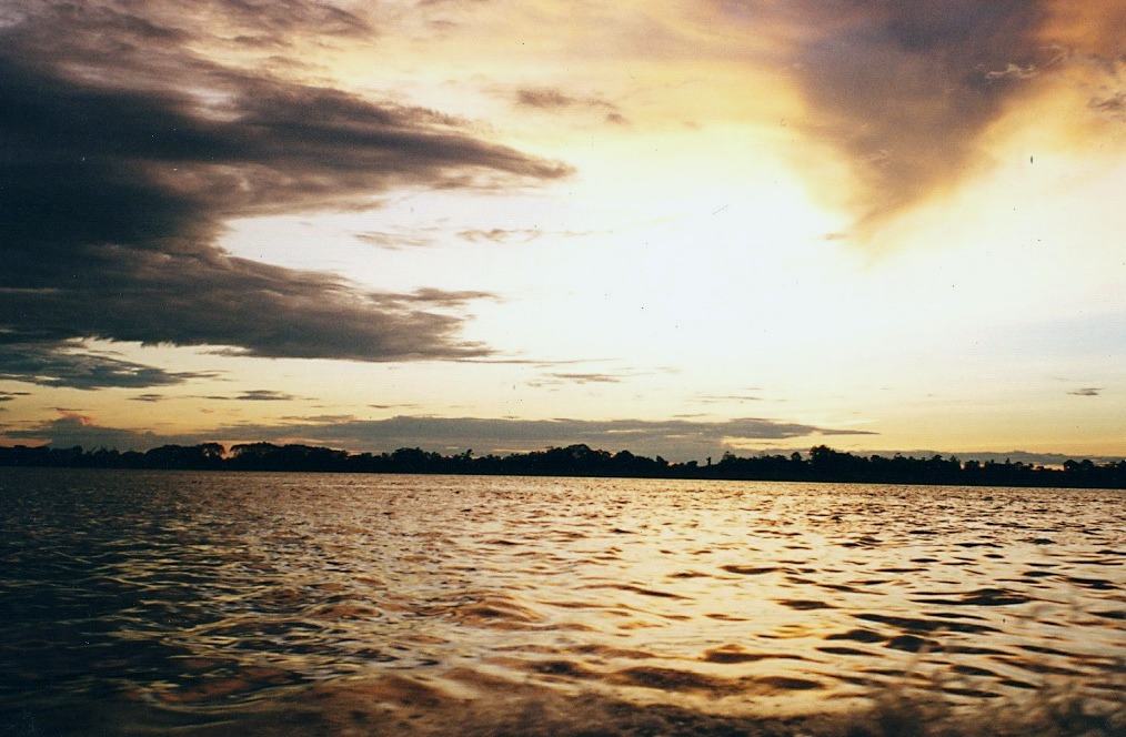 sunset over a wide river, dark cloud at left