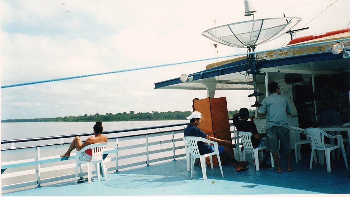 passengers on the upper deck of a river boat