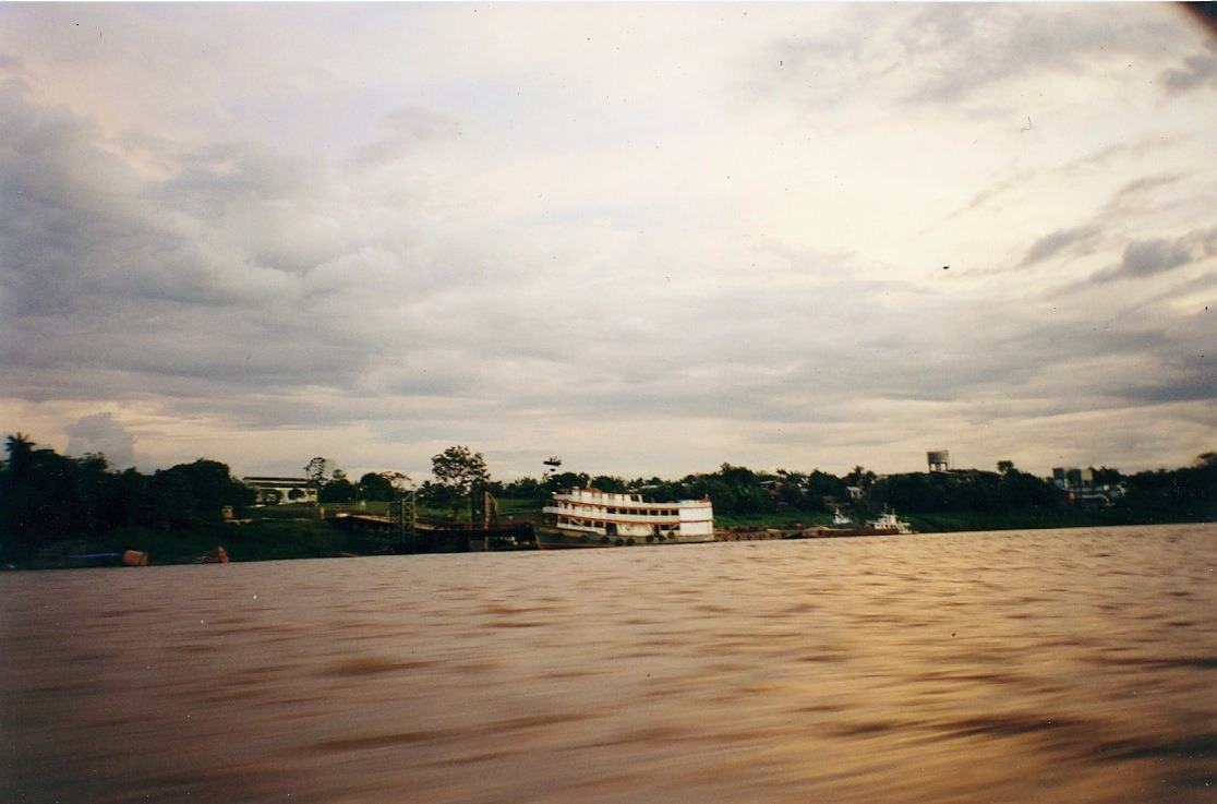 a river boat moored at a wooded bank