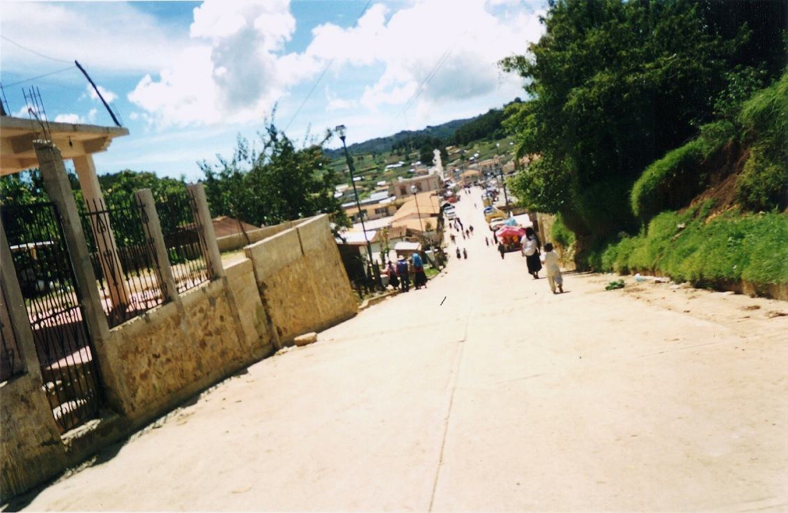 a steep street running downhill into a hill town